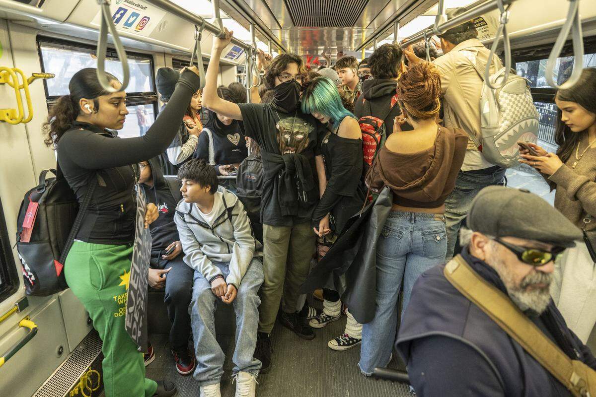 Burbank and McClatchy High School students ride a light rail train to downtown Sacramento during a student-led school walkout against ICE on Friday.