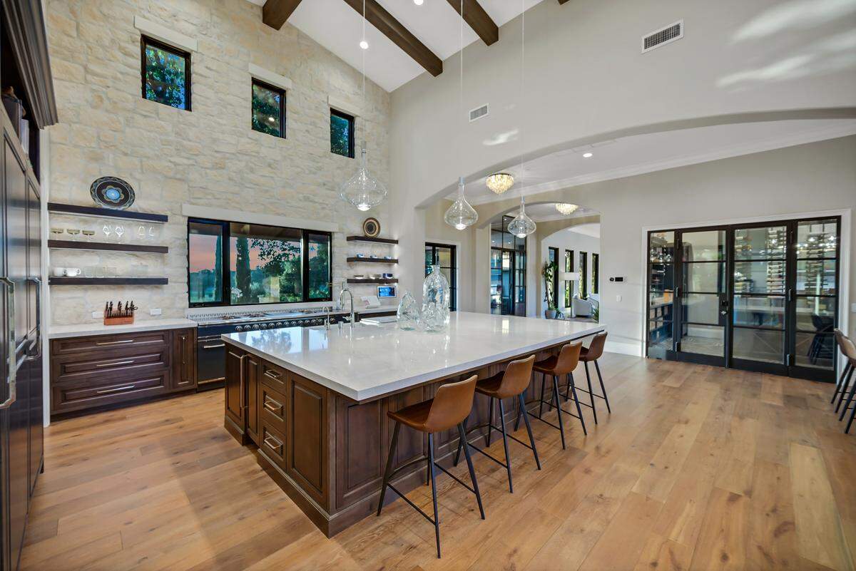 The professional kitchen has a large island, a 92-inch custom range and a dirty kitchen.