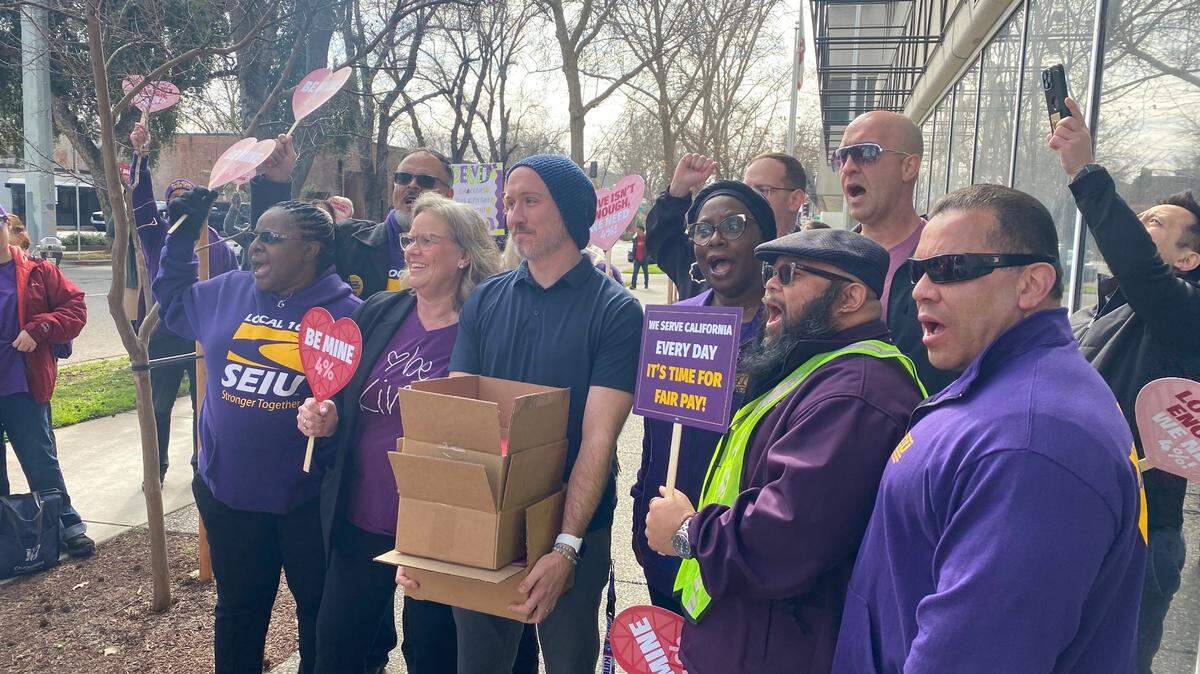 SEIU Local 1000 members with Jeff Keil, center, a labor relations officer with the California Department of Human Resources, after delivering petitions, demanding the state provide public employees a 4% salary increase in July.