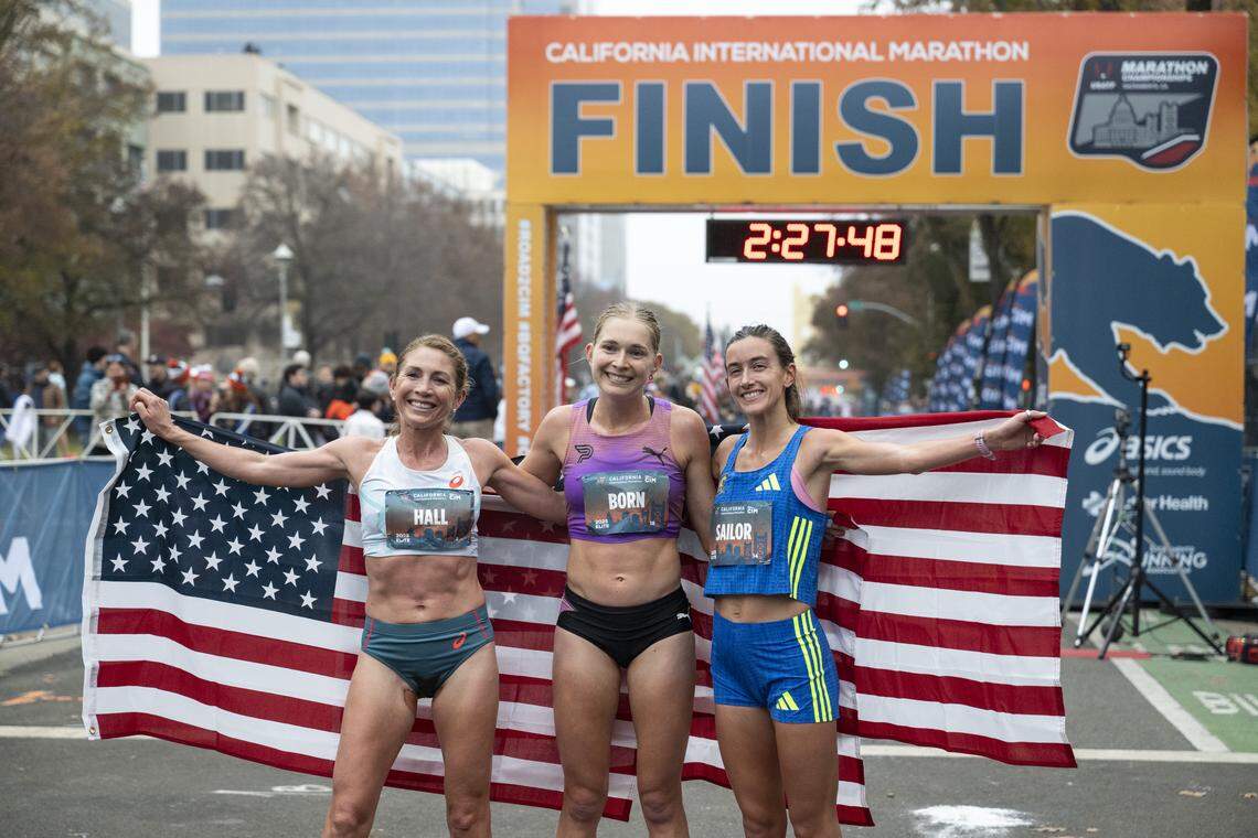 The women’s division’s top three finishers, Molly Born, center, Sara Hall, left, and Megan Sailor, right, pose after winning the California International Marathon in Sacramento on Sunday, Dec. 7, 2025.