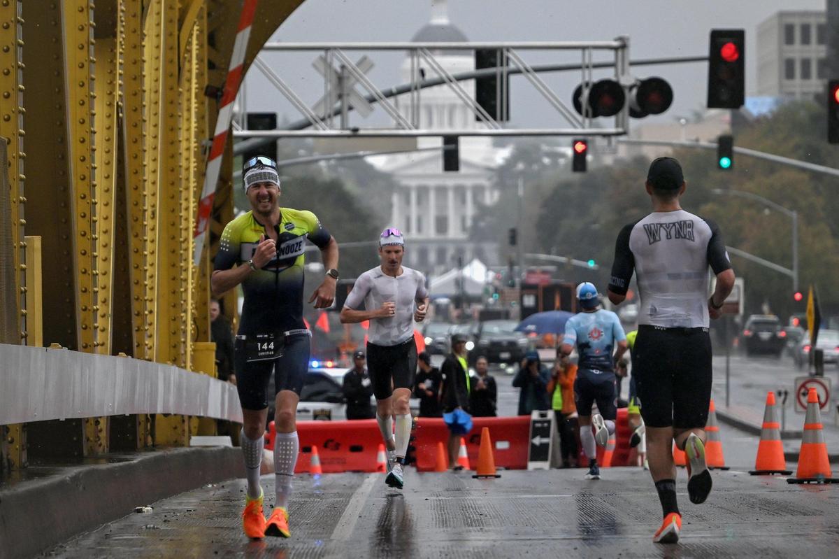 Runners cross on Tower Bridge during the Ironman California triathlon on Sunday.