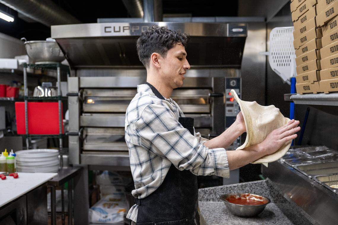 Manager Jackson Wells prepares pizza dough at Dodici Pizza in Sacramento on March 6.