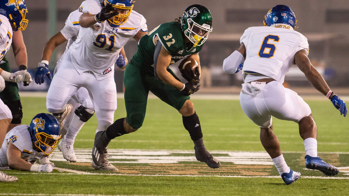 Sacramento State Hornets running back Cameron Skattebo (32), center, runs on a delayed draw for a gain against South Dakota State during the first quarter of their second-round NCAA FSC college football playoff game Saturday, Dec. 4, 2021, at Hornet Stadium in Sacramento.