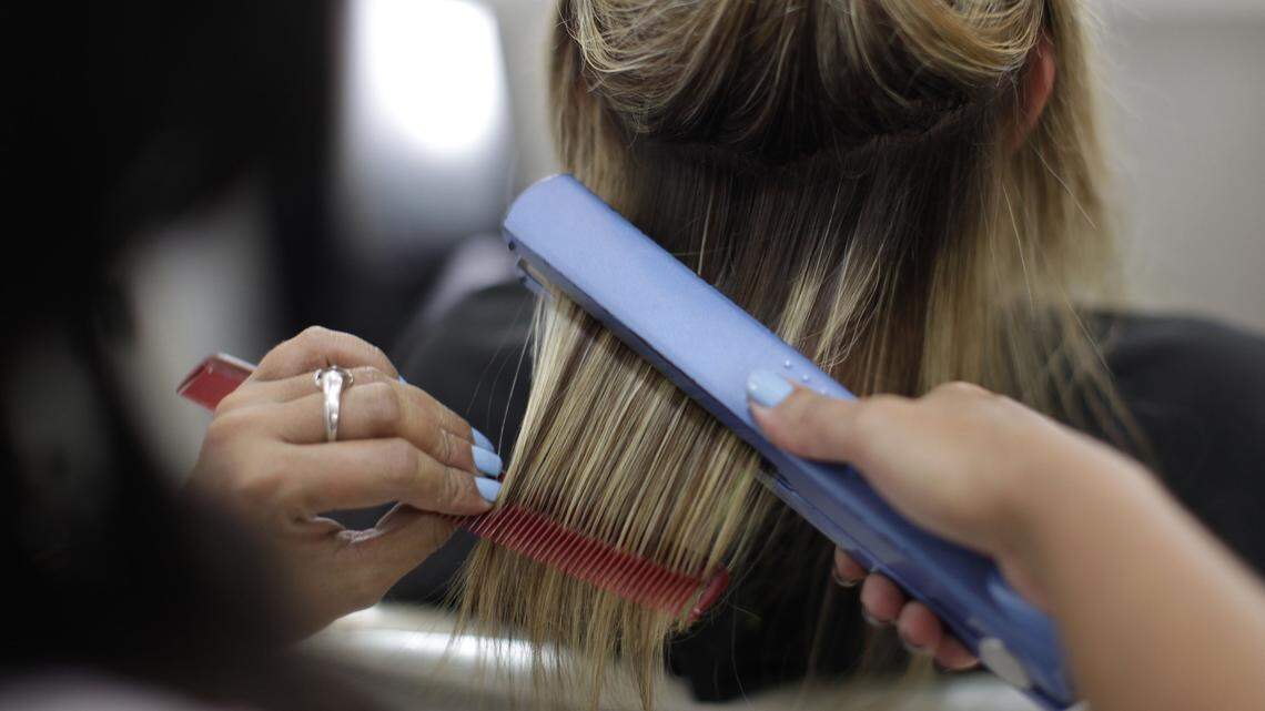 A client gets a hair-straightening treatment known as the Brazilian Blowout. High levels of formaldehyde used in the original treatment has caused concern, both for stylists and their clients.