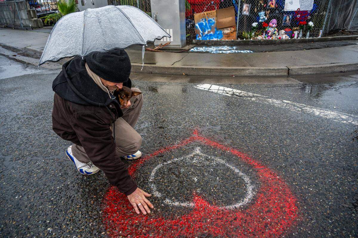 Phillip Minton touches the heart he painted for Wendy Connell, who said was the love of his life, earlier this month at the intersection of Roseville Road and Longview Drive in North Highlands, where she was fatally hit by a truck in January.