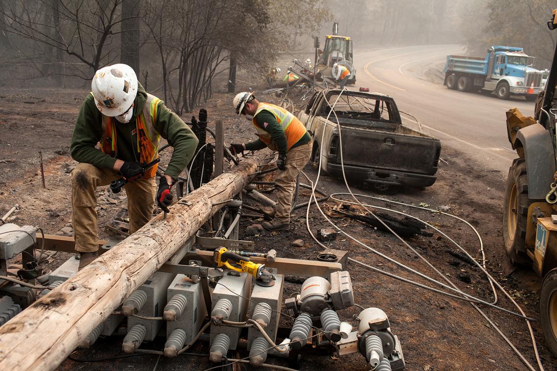 PG&E workers take care of broken power lines after the Camp Fire ripped through Paradise, Calif., on November 15, 2018.