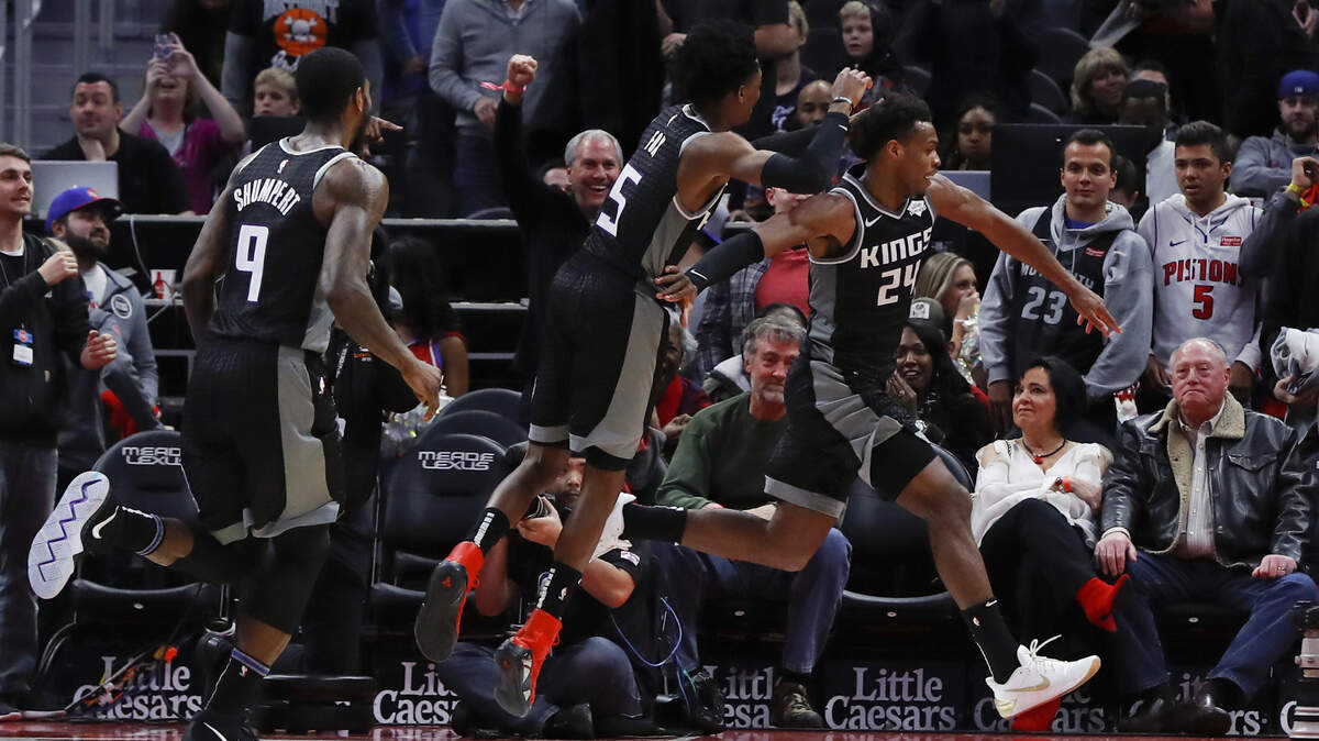 Kings guard Buddy Hield (24) runs around the court in celebration after hitting the game-winning 3-pointer Saturday in Detroit. The Kings beat the Pistons 103-101.
