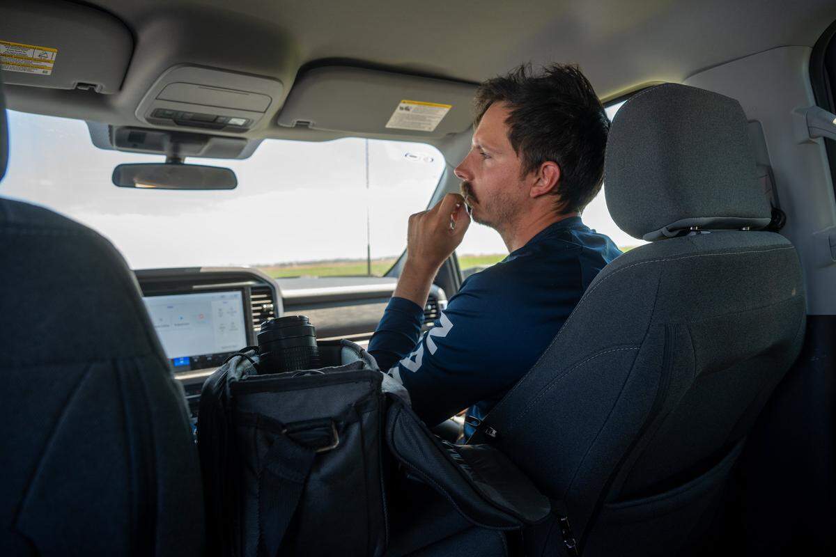 Patrick Carr, who works as the avian monitoring crew lead with The Nature Conservancy, rides in a vehicle on Aug. 22 in Yolo County. Carr says he has been interested in birds since he was a kid.