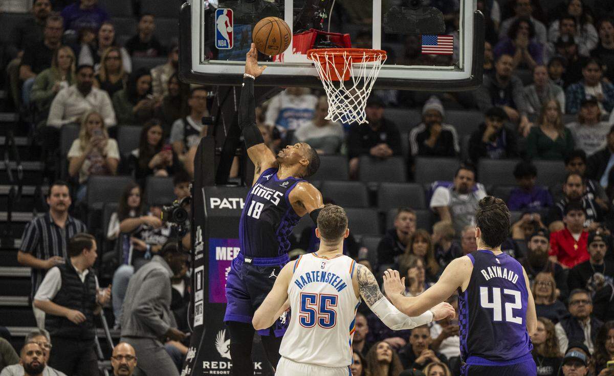 Sacramento Kings guard Russell Westbrook (18) makes a basket against the Oklahoma City Thunder's Isaiah Hartenstein during an Emirates NBA Cup in-season tournament game at Golden 1 Center on Friday.