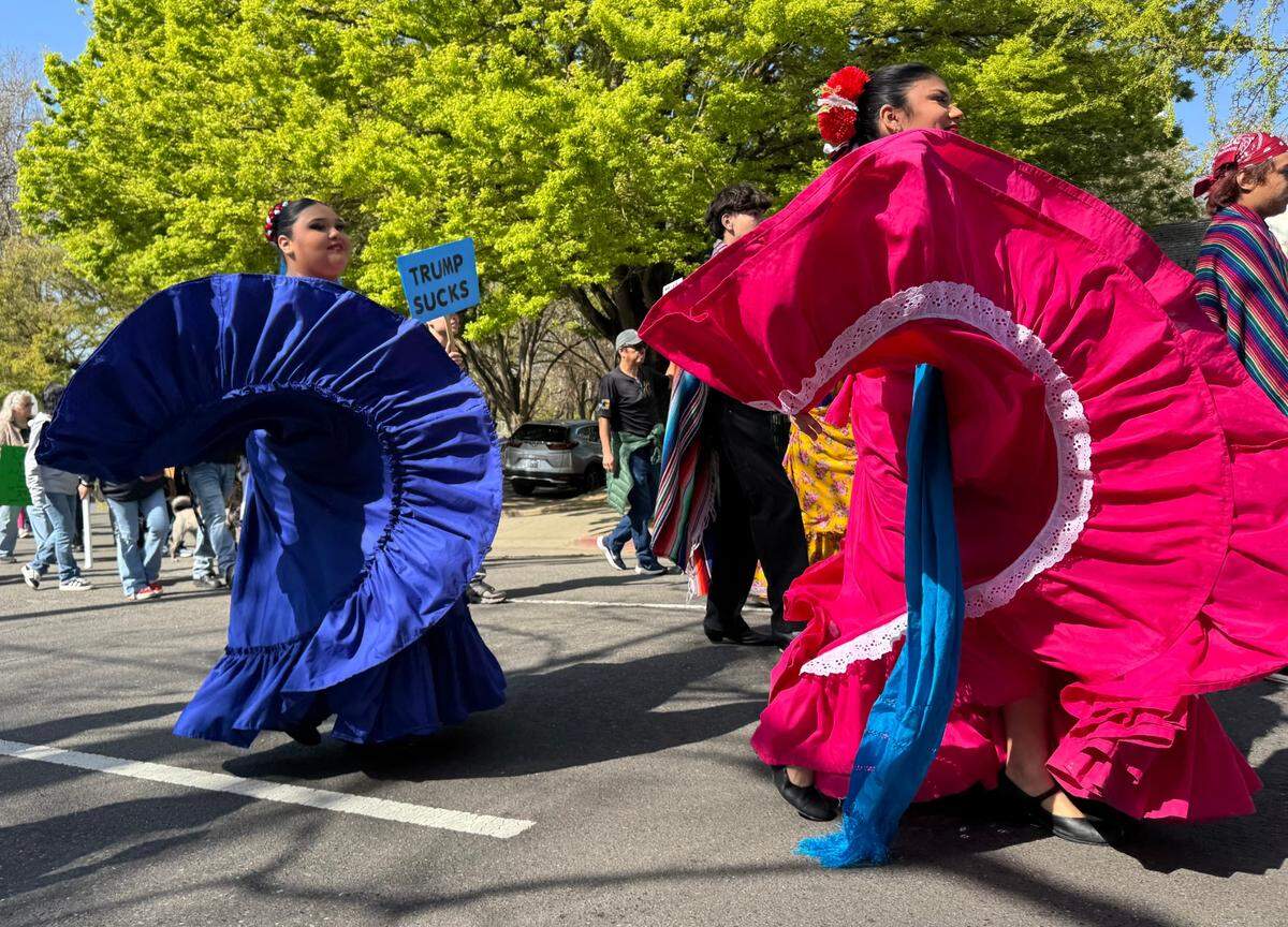 Grant Union High School student Estrella Avila, in the pink skirt, swirls her dress during the Cesar Chavez march through downtown Sacramento streets Saturday.