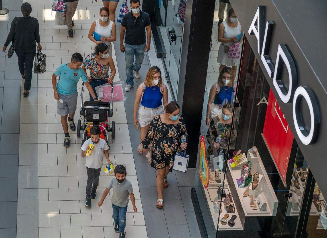 Shoppers many wearing masks spend a final day at Arden Fair mall before it closes again due to rising cases of the coronavirus on Monday, July 13, 2020. Earlier in the day, California Gov. Gavin Newsom announced additional closures in the state, including gyms, indoor shopping malls and indoor church worship services as the rate of positive tests for COVID-19 rise.