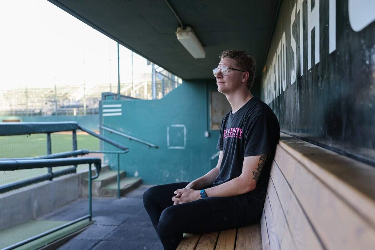 Stone Churby sits in the Sacramento State dugout on June 21. He suffered a torn ulnar collateral ligament in his elbow in April, ending his senior season. “It feels weird that I’m done pitching here,” he said.