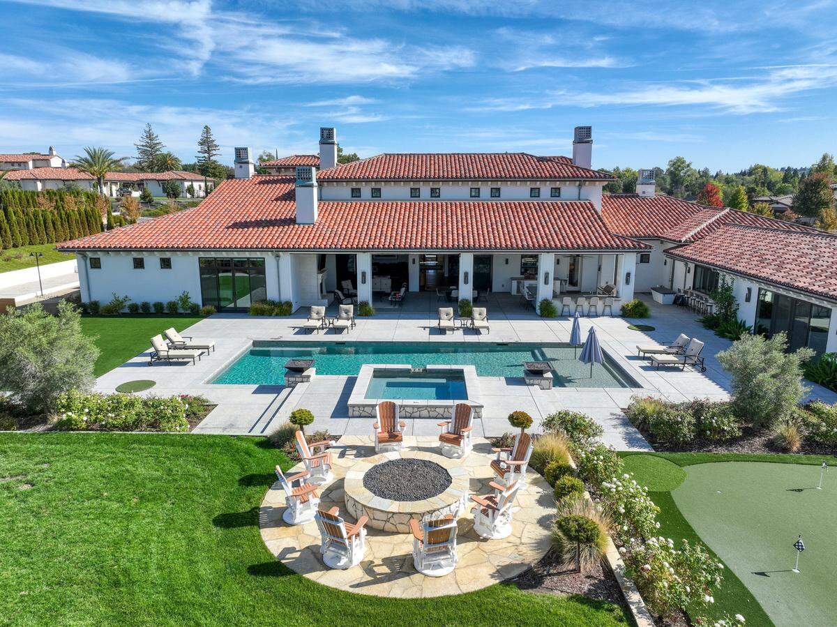 A pool, fire pit, bocce ball court and outdoor kitchen enhance the grounds of the Granite Bay estate.