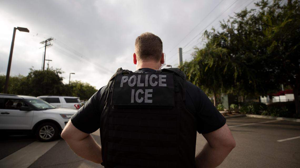 In this July 8, 2019, file photo, a U.S. Immigration and Customs Enforcement (ICE) officer looks on during an operation in Escondido.