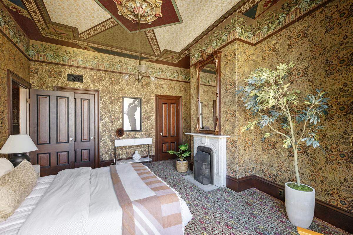 Under 11-foot ceilings, all three bedrooms of the home are restored with period details.