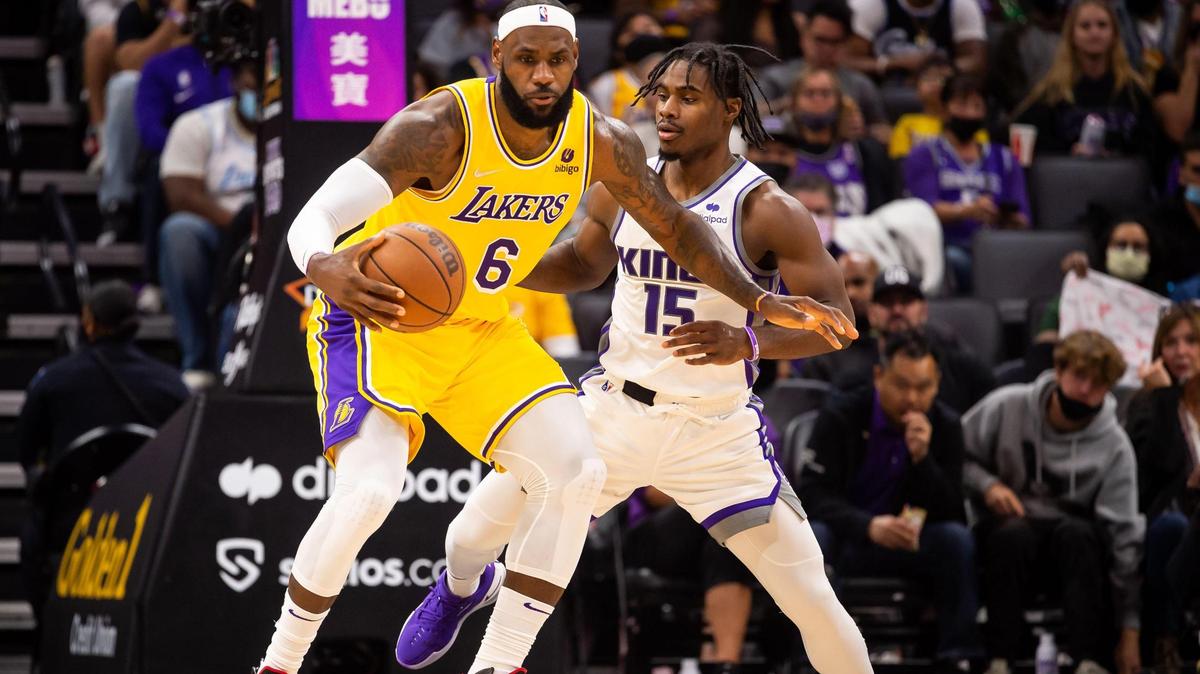 Sacramento Kings guard Davion Mitchell (15), right, defends against Los Angeles Lakers forward LeBron James (6) during the first half of their final preseason NBA basketball game Thursday, Oct. 14, 2021, at Golden 1 Center in downtown Sacramento.