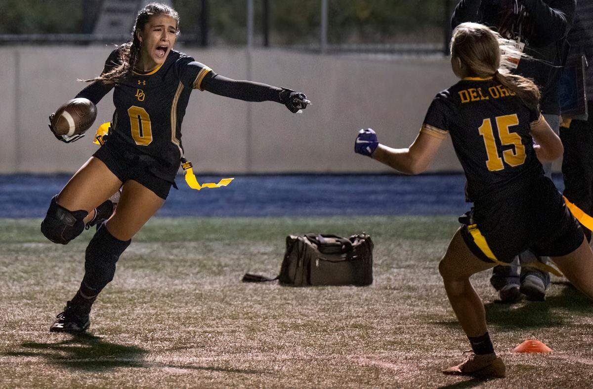 The Del Oro Eagles’ Bella Von Seipler (0) celebrates her game-winning touchdown reception against the Oak Ridge Trojans with Sam Pitzer (15) In the Sac-Joaquin Section girls flag football Division I championship game at Cosumnes River College in Sacramento on Saturday.