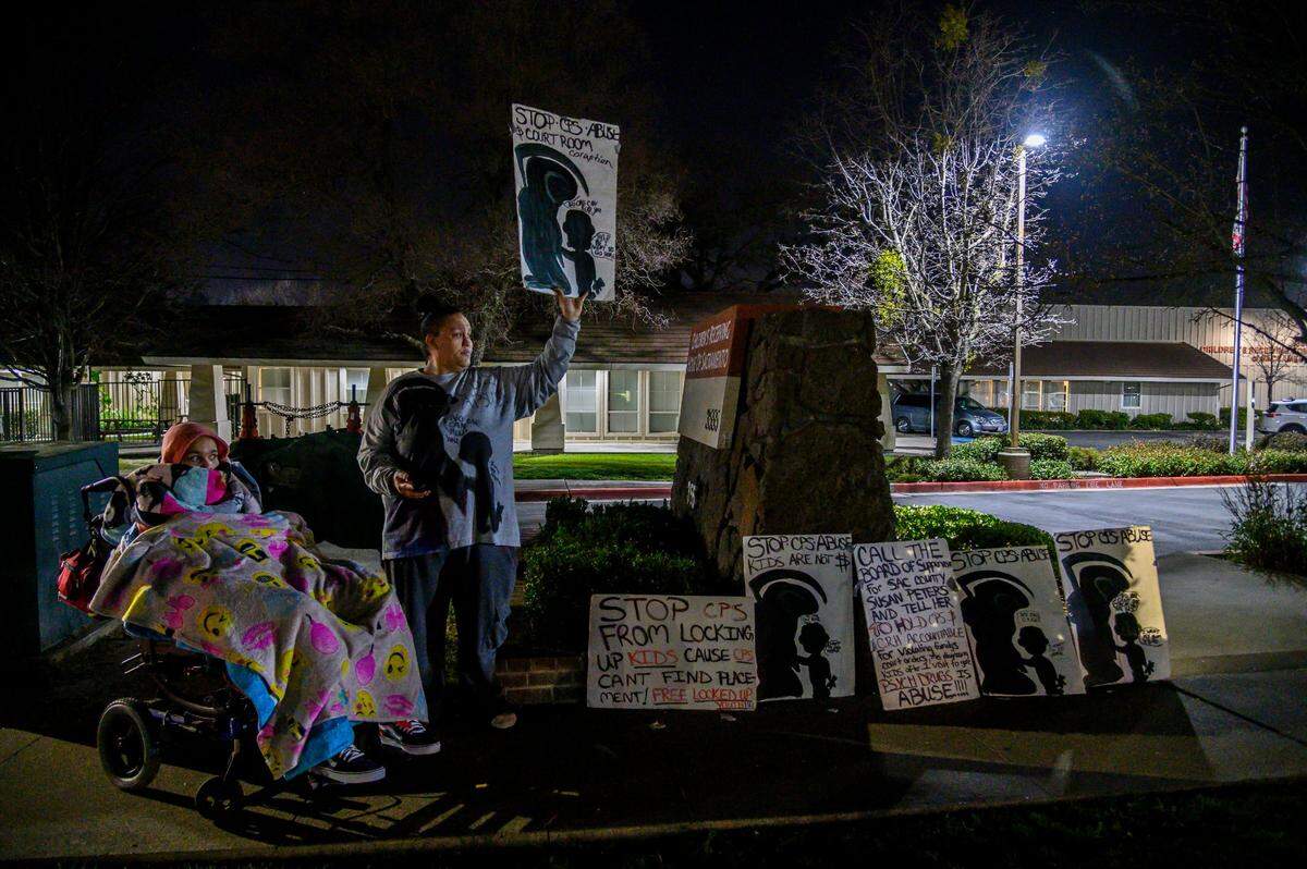 Felicia Clark protests outside the Children’s Receiving Home of Sacramento with daughter Felicia Brent-Velasquez, 18, wrapped in blankets in her wheelchair, in Sacramento on Friday, Feb. 14, 2020. Clark became a frequent protester at the home after her four children were placed there.