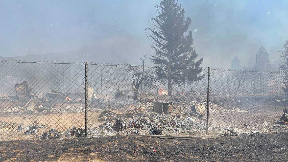 Flames and debris are seen in the Mill Fire near Weed, Calif., on Friday, Sept. 2, 2022. A wildfire erupted at a timber mill near the town of Weed in Siskiyou County on Friday, prompting evacuations across a wide area and closing Highway 97.