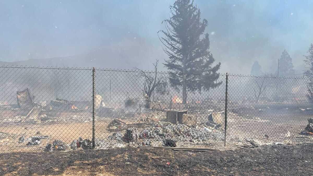 Flames and debris are seen in the Mill Fire near Weed, Calif., on Friday, Sept. 2, 2022. A wildfire erupted at a timber mill near the town of Weed in Siskiyou County on Friday, prompting evacuations across a wide area and closing Highway 97.