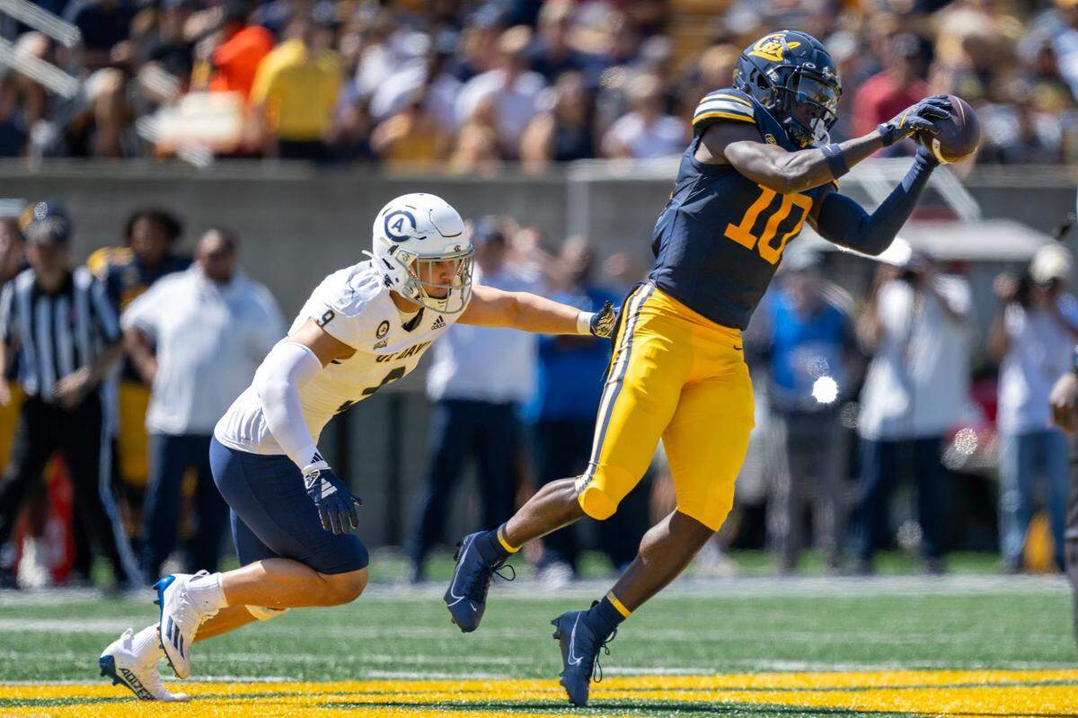 The UC Davis Aggies linebacker David Meyers (9) prepares to tackle Berkeley Bears tight end Corey Dyches (10) on Aug. 31 at Memorial Stadium in Berkeley.