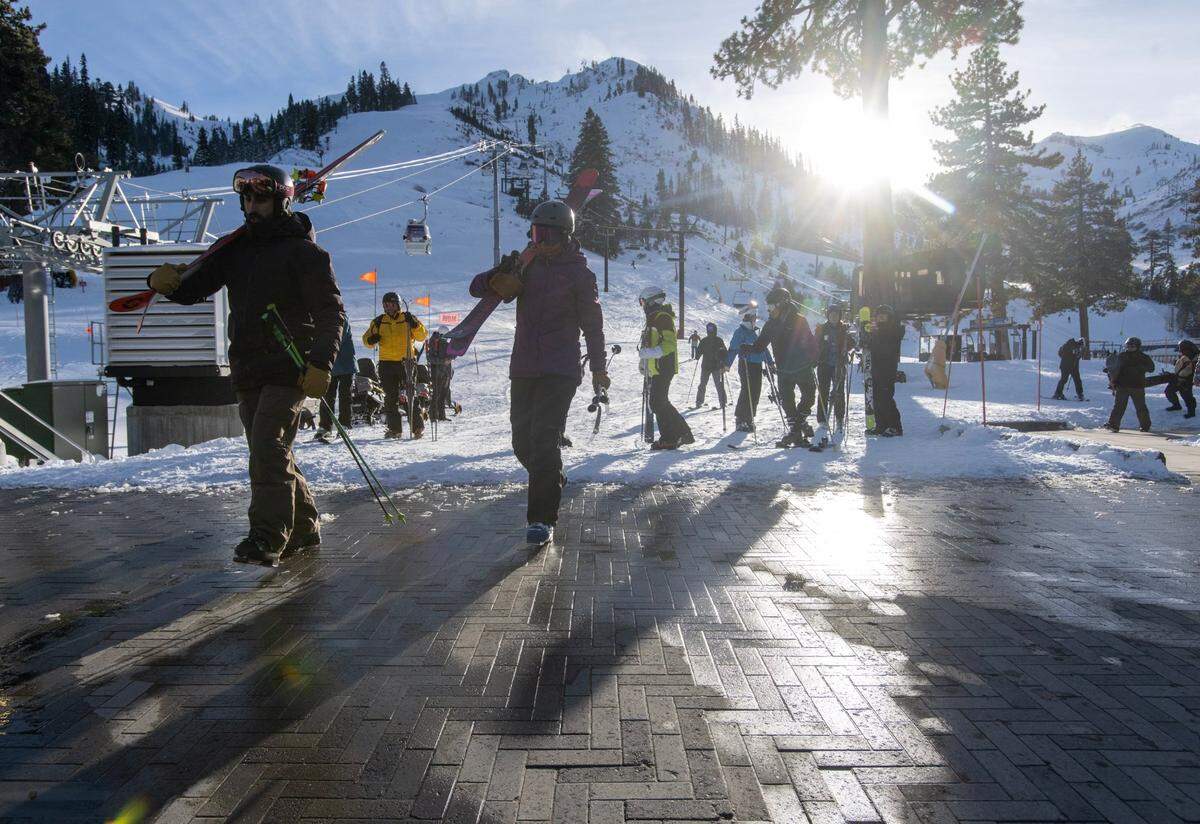 Skiers and snowboarder finish their run at Palisades Tahoe on Thursday, Jan. 11, 2024 in Placer County.