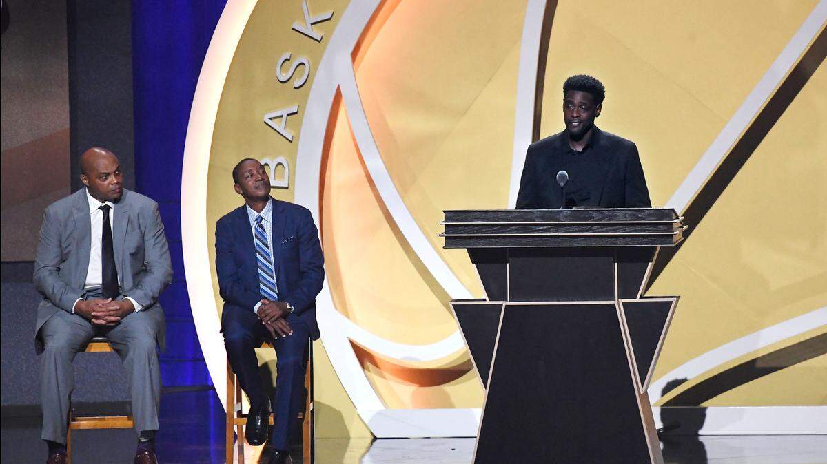 Inductee Chris Webber speaks as presenters Charles Barkley, left, and Isiah Thomas, center, look on, during the 2021 Basketball Hall of Fame Enshrinement ceremony, Saturday, Sept. 11, 2021, in Springfield, Mass. (AP Photo/Jessica Hill)