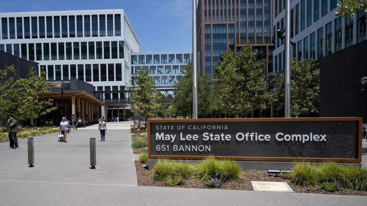 People walk through a courtyard at the May Lee State Office Complex in Sacramento on Wednesday, July 1, 2026, the first day of Gov. Gavin Newsom’s return-to-office order.