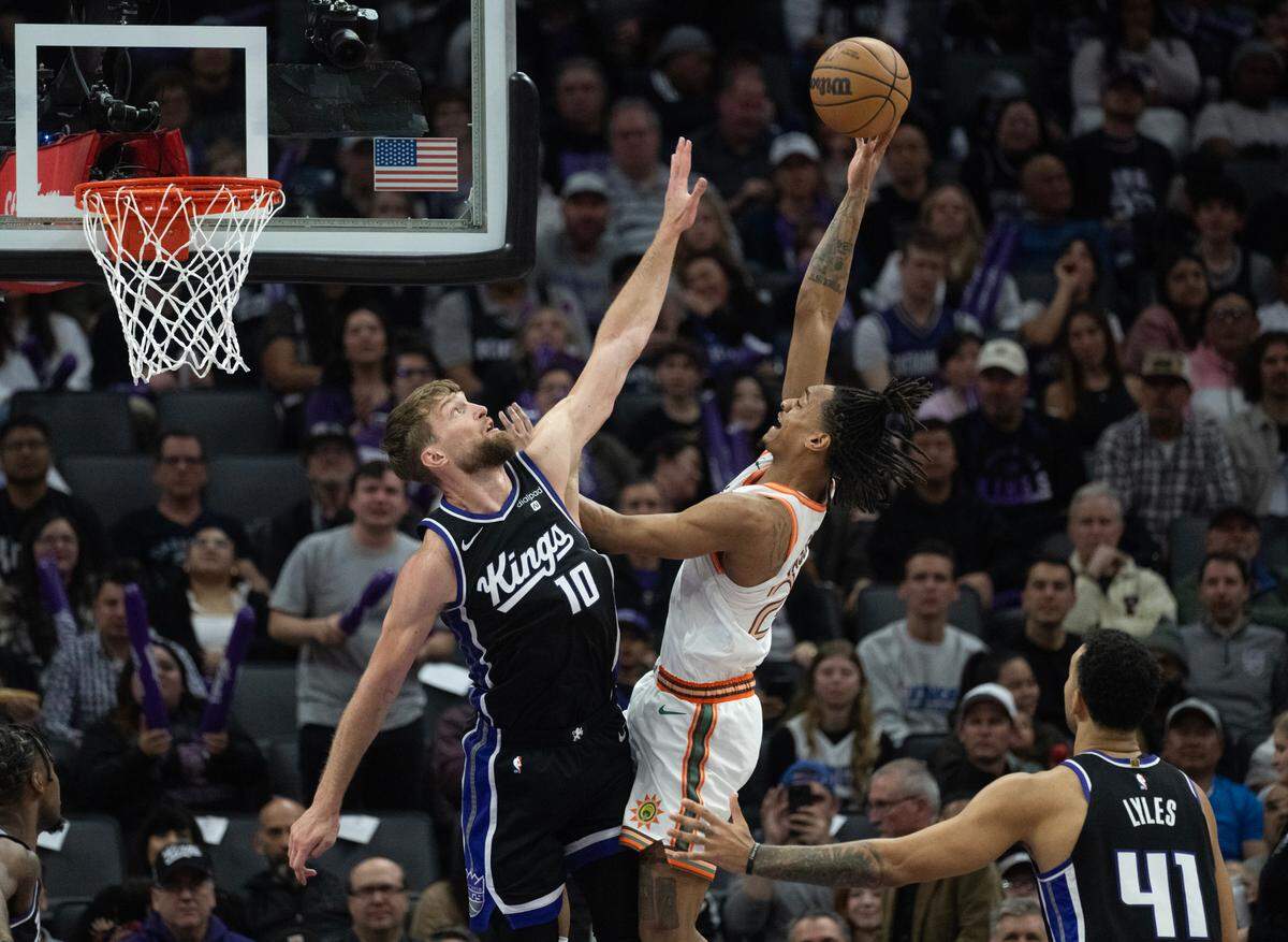 Sacramento Kings Domantas Sabonis defends against San Antonio Spurs Devin Vassell during a game at Golden 1 Center on Thursday, March 7, 2024 in Sacramento.