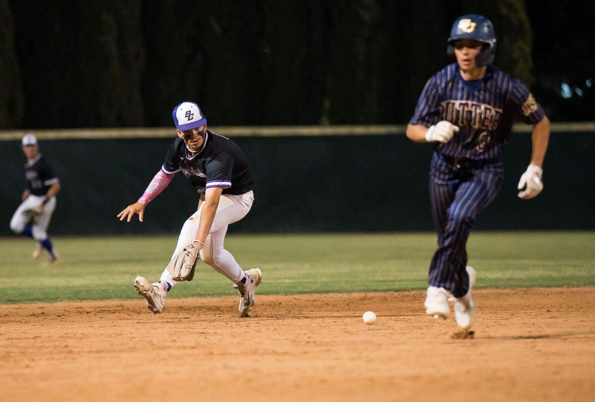 Bradshaw Christian Pride shortstop Micah Nicholson (8) fields a ground ball as Sutter Huskies infielder Jordan Lee (9) is safe at third in the 11th inning at the CIF Sac-Joaquin Section Division V high school baseball championship game in 2023 at Sacramento City College.