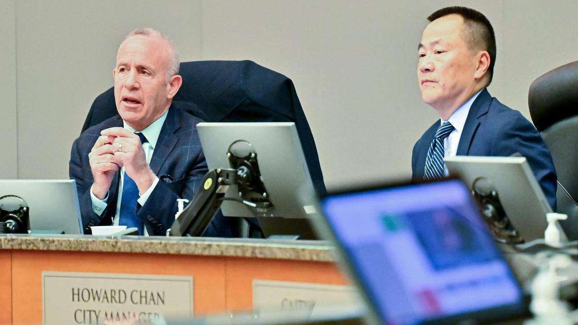 Sacramento Mayor Darrell Steinberg, left, speaks about the proposed raise for City Manager Howard Chan, right, at the City Council meeting on Tuesday, Jan. 9, 2024.