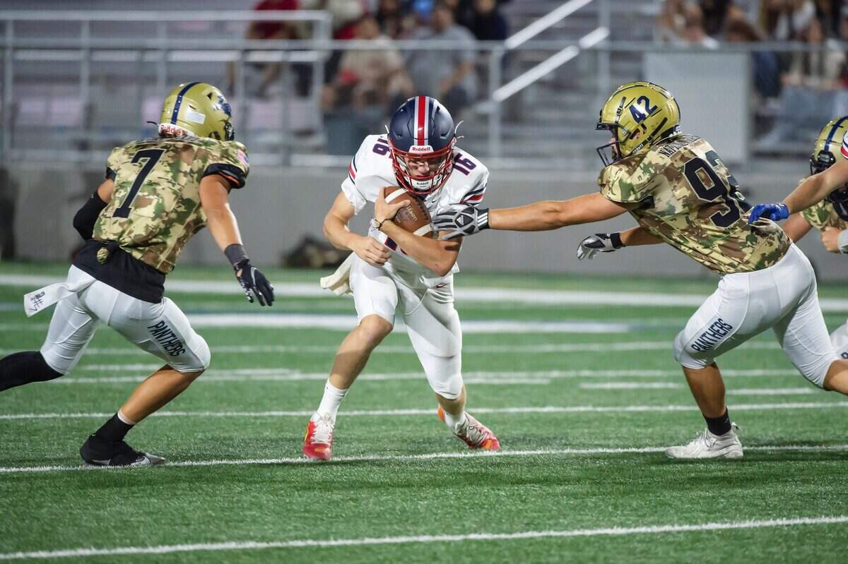 Pleasant Grove Eagles quarterback Cole Davis (16) runs the ball before being tackled by the West Park Panthers’ Topher Petersen (7) on Friday, Sept. 1, 2023, at West Park High School in Roseville.