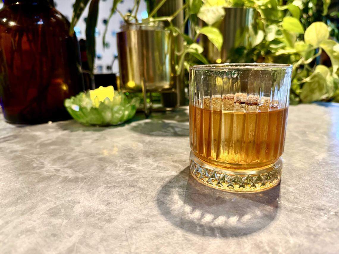 The Green Room in East Sacramento' Autumn Hog ($18) uses a mix of bacon fat-washed bourbon and apple brandy, apple-maple syrup, Angostura Bitters, and black walnut bitters, served over a large cube with a petite crisp of bacon perched on top.
