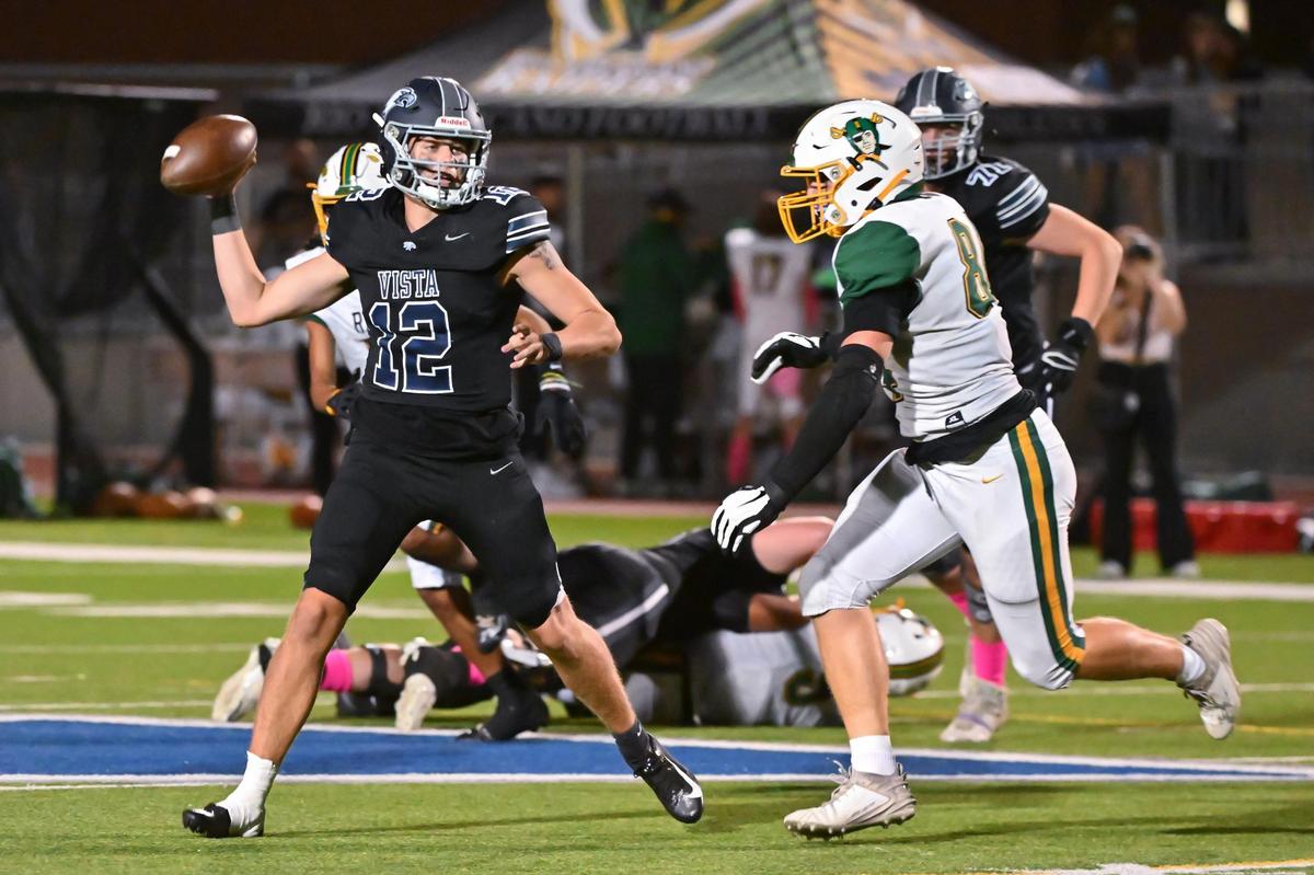 Vista del Lago Eagles quarterback John Koett (12) passes the ball to wide receiver Dominic Rostami (1) who runs the ball to the 10-yard line in the first half of the game on Friday, Oct. 13, 2023, at Vista Del Lago High School in Folsom.