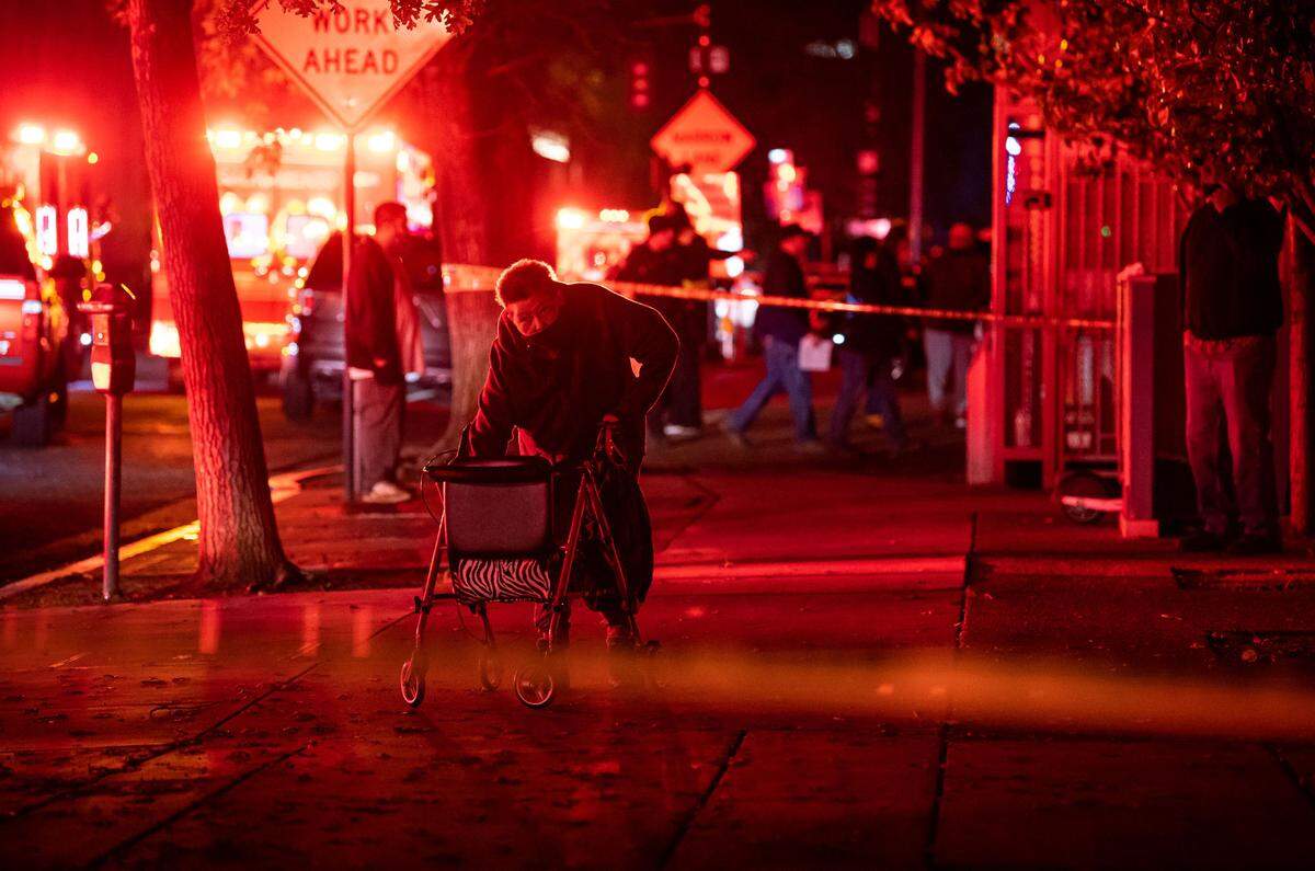 Alberteen Earl, 73, who has lived in the 12-story senior living tower at 626 I St. for eight years, walks down the block after being evacuated from the building due to unsafe conditions following a power outage after a fire at a SMUD power substation earlier Tuesday, Dec. 14, 2021, in downtown Sacramento. “I’m waiting for my daughter,” Earl said. “It was kind of hard coming down,” she added, since elevators were not functioning, “but the fire people are so good.” Sacramento Fire Department, the police and transit personnel assisted in the evacuation.