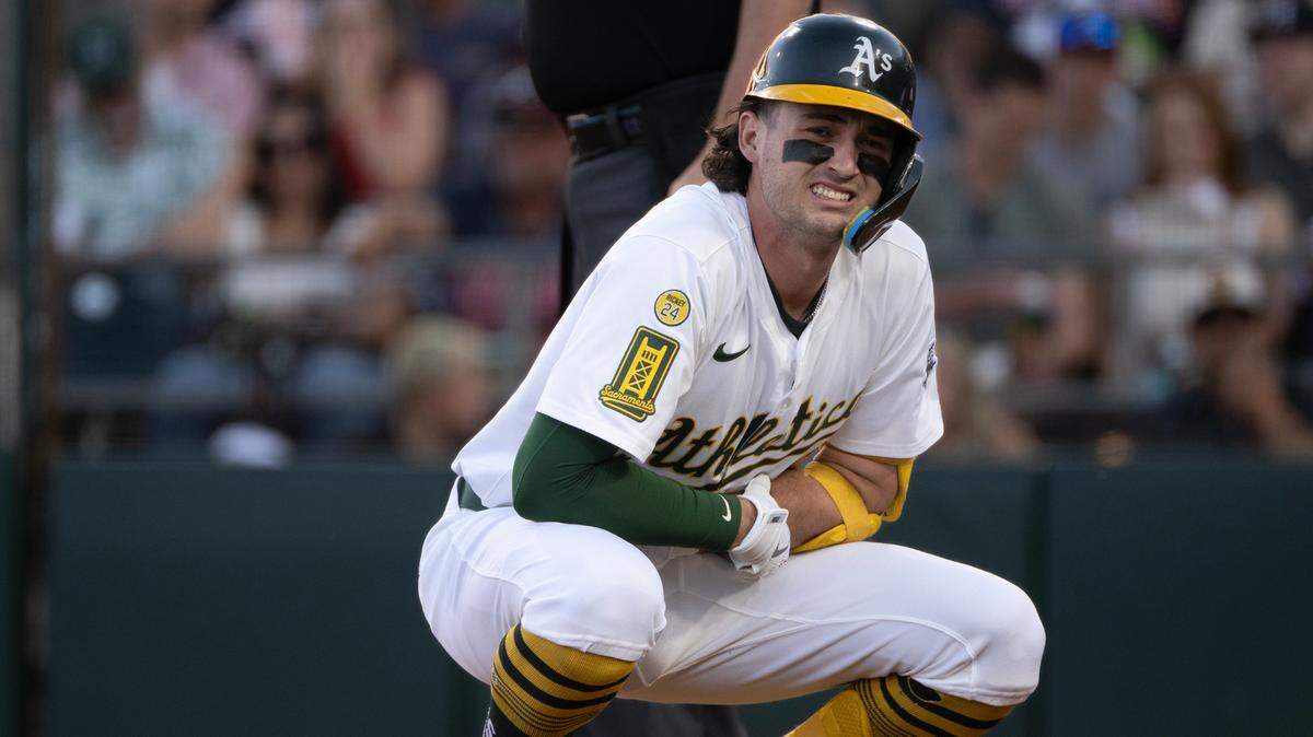 Athletics hitter Jacob Wilson holds his left wrist after being hit by a pitch thrown by Atlanta Braves pitcher Didier Fuentes on July 8 at Sutter Health Park. The A’s placed Wilson on the 10-day injured list Tuesday, retroactive to Saturday, for a fractured forearm.