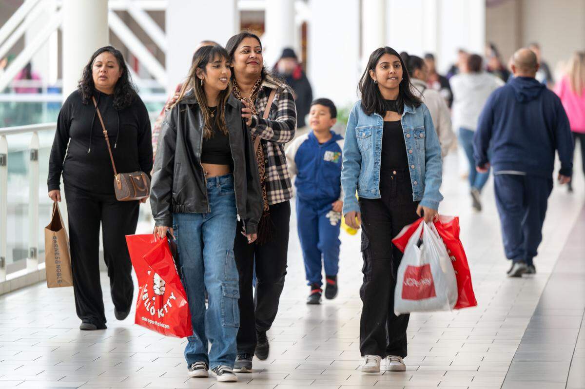 Anshu Lata, center, of Stockton shops with her daughters, Taanvi Trishika, second from left, and Rhea Lal, right, during Black Friday shopping weekend at the Arden Fair mall in 2024.