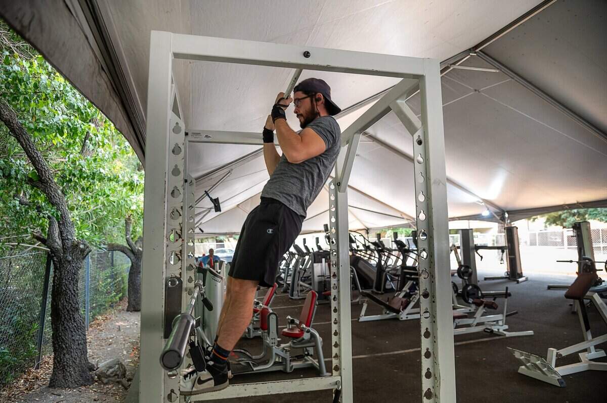 Carlos Gonzalez, 28, works out at the outdoor gym area set up in the parking lot at the California Family Fitness in the Greenhaven area on Friday, Sep 4, 2020. Gonzalez has been working out at home to keep in shape and recently returned to the gym.