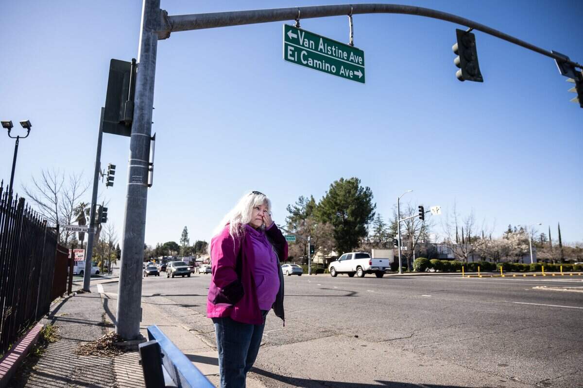 Lisa Wiley gets emotional in February while standing at the intersection where her son, Robert Jenson, was killed in by a hit-and-run driver in 2022.