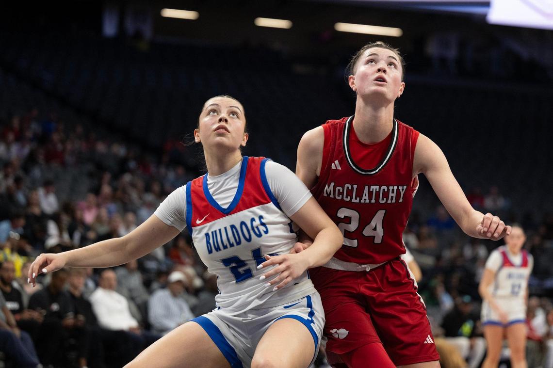 The Folsom Bulldogs’ AnnaBell Dotson (21) and the McClatchy Lions’ Daisy Throckmorton (24) position for a rebound in the 2025 CIF Sac-Joaquin Section Division I girls basketball championship game at Golden 1 Center.