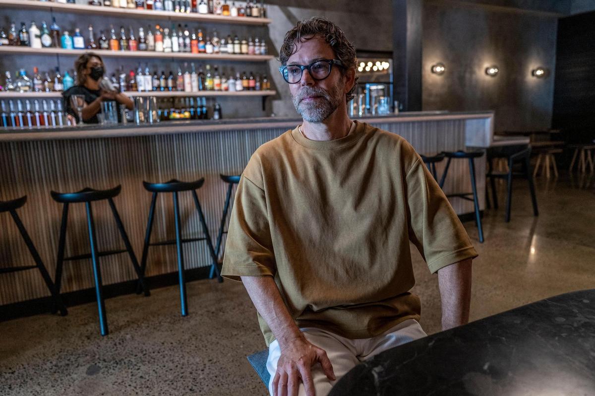 Michael Hargis, owner of Holy Spirits, relaxes in the cocktail bar of his newest venture in midtown Sacramento on Aug. 16. At the entrance is a boutique bottle shop where rare and allocated spirits can be purchased to go.