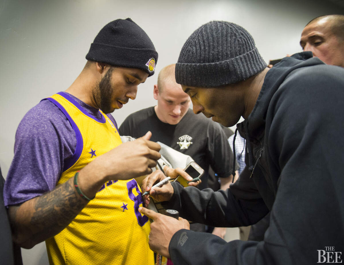 French train hero Anthony Sadler, of Sacramento, has a jersey signed by Los Angeles Lakers forward Kobe Bryant (24) after the Lakers game against the Sacramento Kings.