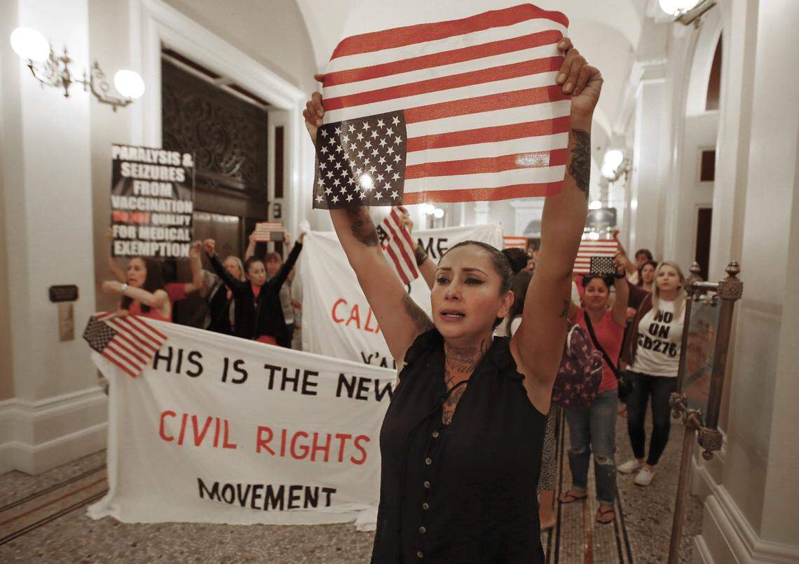 Denise Aguilar, right, joins others in a march through the Capitol to protest the state Legislature’s passage of a measure to crack down on doctors who sell fraudulent medical exemptions for vaccinations, in Sacramento, Calif., Wednesday, Sept. 4, 2019. Lawmakers sent the bill to Newsom on Wednesday but he said he wants last-minute changes. (AP Photo/Rich Pedroncelli)