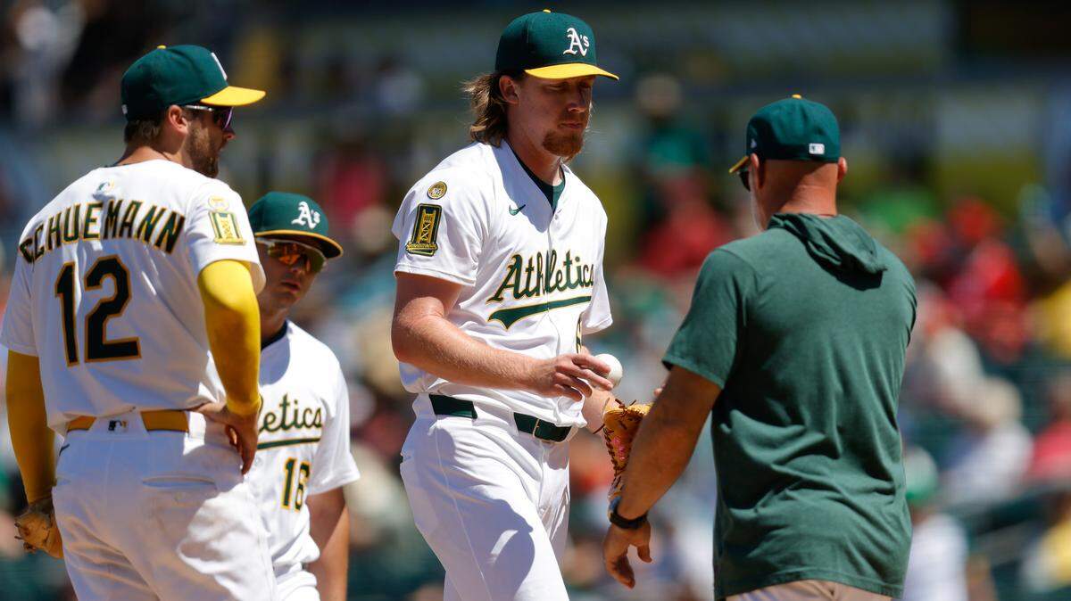May 22, 2025; West Sacramento, California, USA; Athletics pitcher Grant Holman (67) is removed from the game by manager Mark Kotsay (7) during the seventh inning against the Los Angeles Angels at Sutter Health Park. Mandatory Credit: Sergio Estrada-Imagn Images
