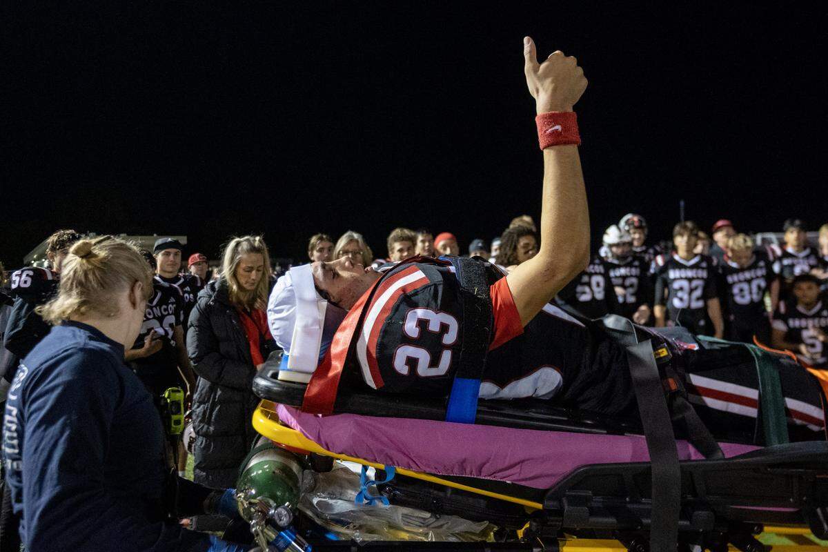 The Bella Vista Broncos' Manny Matta gives the thumbs up to his teammates as paramedics wheel him to an ambulance following the Broncos victory over the Del Campo Cougars on Friday in Fair Oaks.