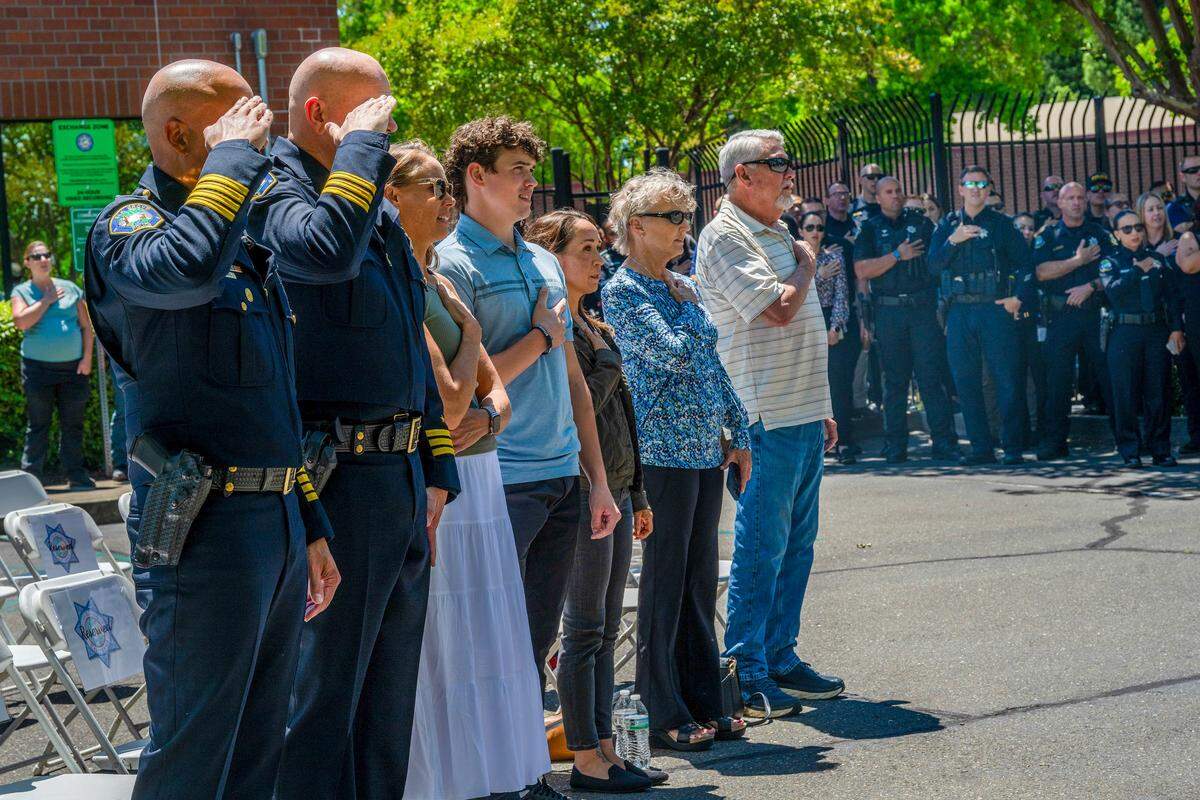 Chief Bobby Davis and Assistant Chief Brian Schopf of the Elk Grove Police Department salute at a dedication ceremony honoring fallen Officer Ty Lenehan on Wednesday in Elk Grove. The department honored Lenehan, killed in the line of duty in 2022, by renaming its campus the Officer Ty Lenehan Public Safety Center and unveiling a memorial plaque recognizing his service and legacy.