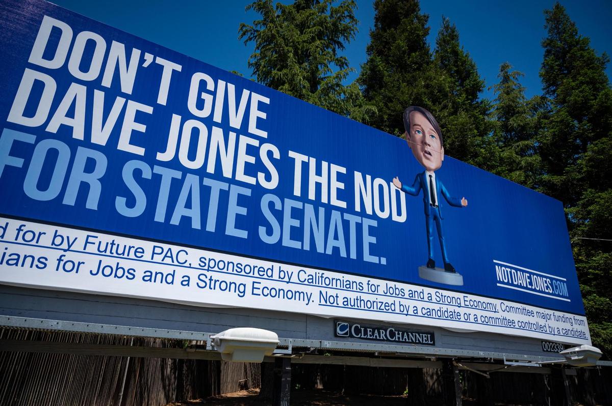 A campaign billboard on Sutterville Road in Sacramento depicts Dave Jones, a candidate for the state’s 8th Senate District, as a bobblehead. Jones is running against Sacramento City Councilwoman Angelique Ashby.