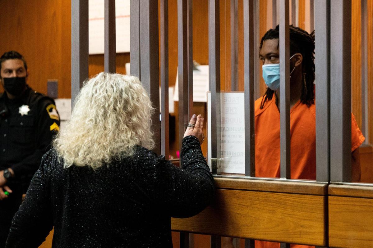 Shooting suspect Dandrae Martin, 26, talks with defense attorney Linda Parisi through the bars of an arraignment cell during his appearance in Sacramento Superior Court in April.