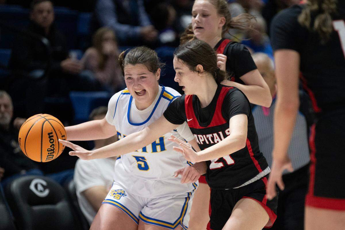 The Faith Christian Lions’ Lauren Harris drives past the Sacramento Adventist Academy Capitals’ Kyla Friedrich during the CIF Sac-Joaquin Section Division VI girls basketball section championship game at on Friday, Feb. 23, 2024, at UC Davis.