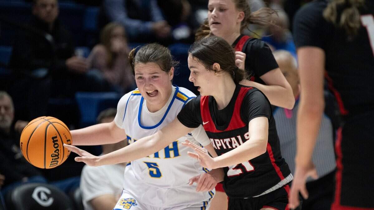 The Faith Christian Lions’ Lauren Harris drives past the Sacramento Adventist Academy Capitals’ Kyla Friedrich during the 2024 CIF Sac-Joaquin Section Division VI girls basketball section championship game.